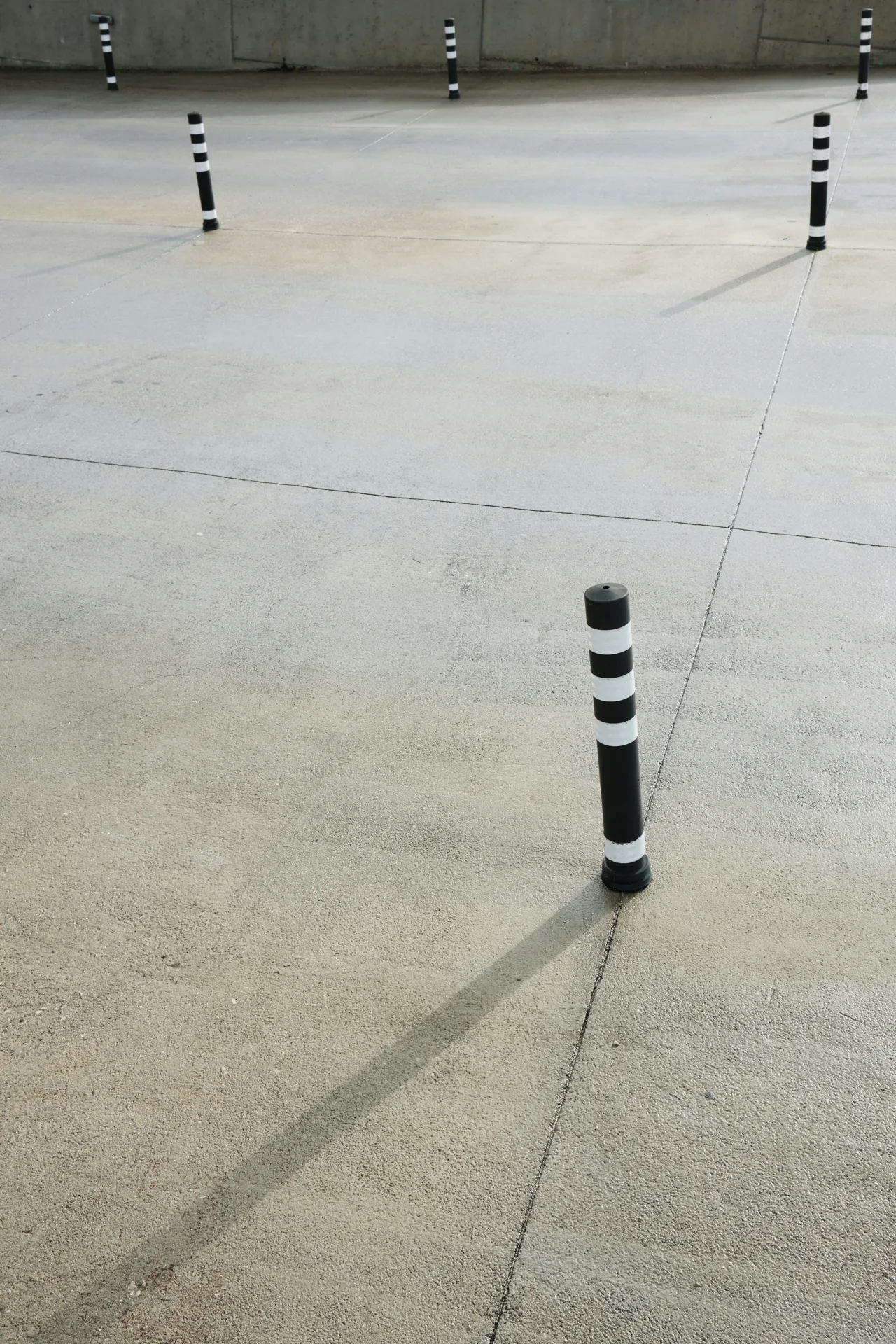 broom-finished concrete parking lot with bollards in Minneapolis