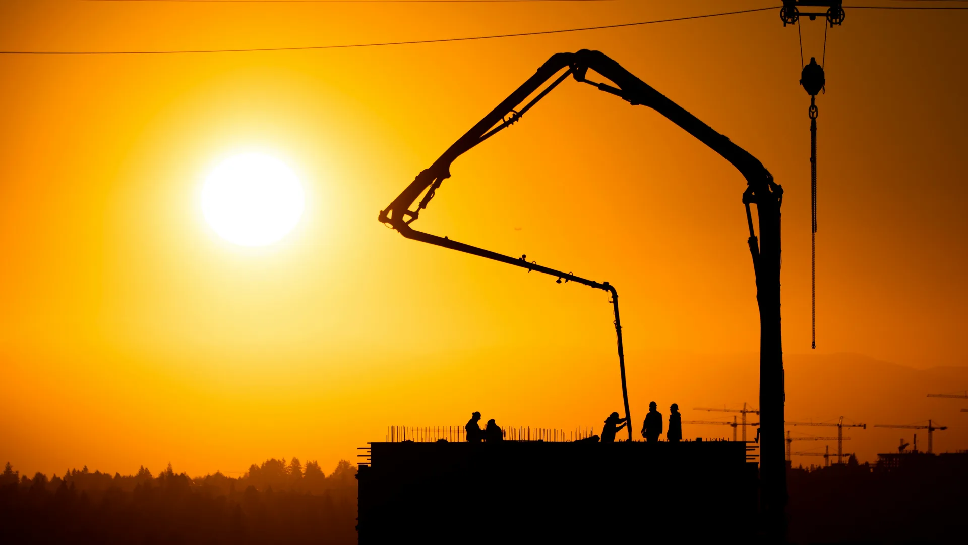 concrete boom pump on a Minneapolis construction site at sunset