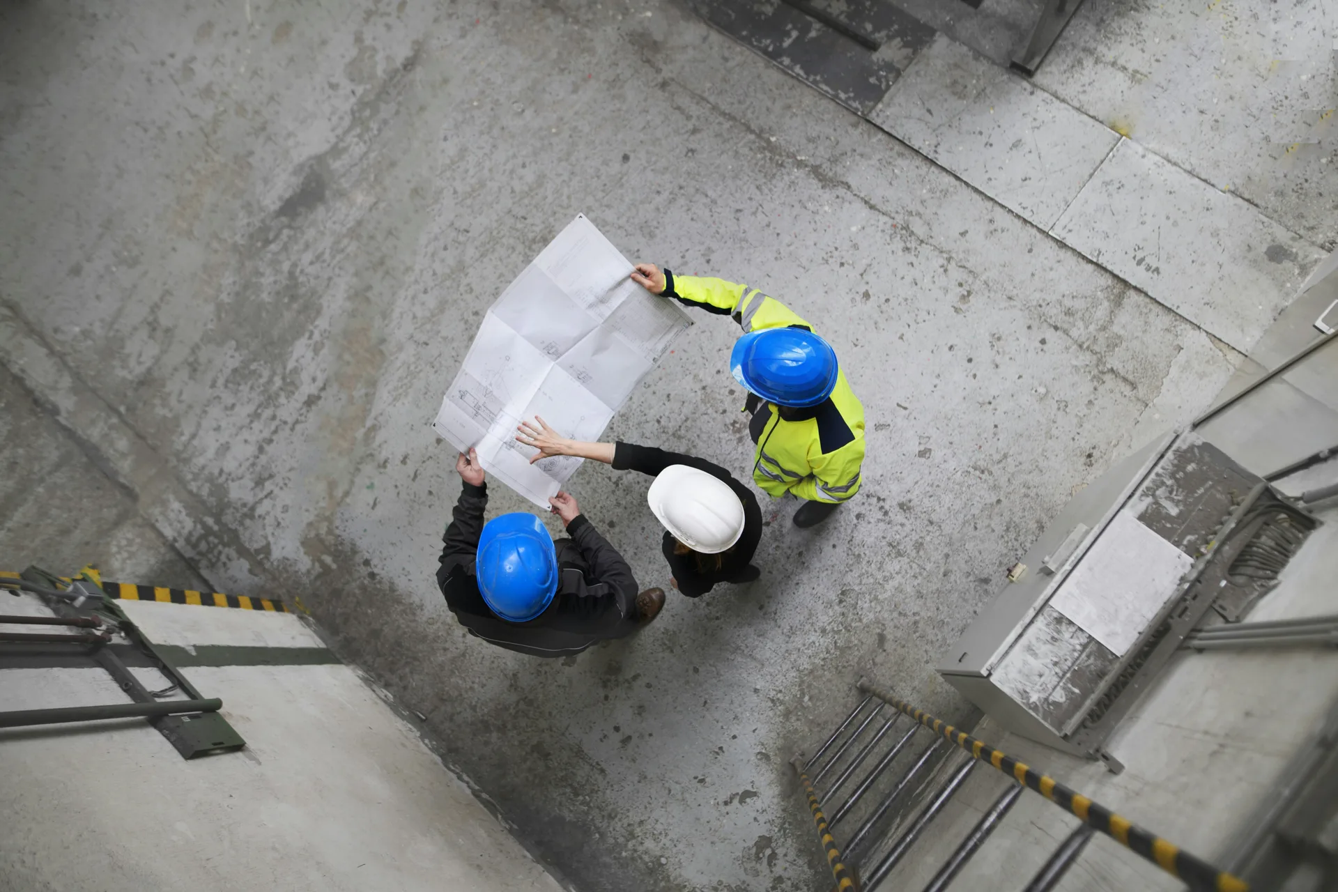 concrete project planning with blueprints laid out overhead