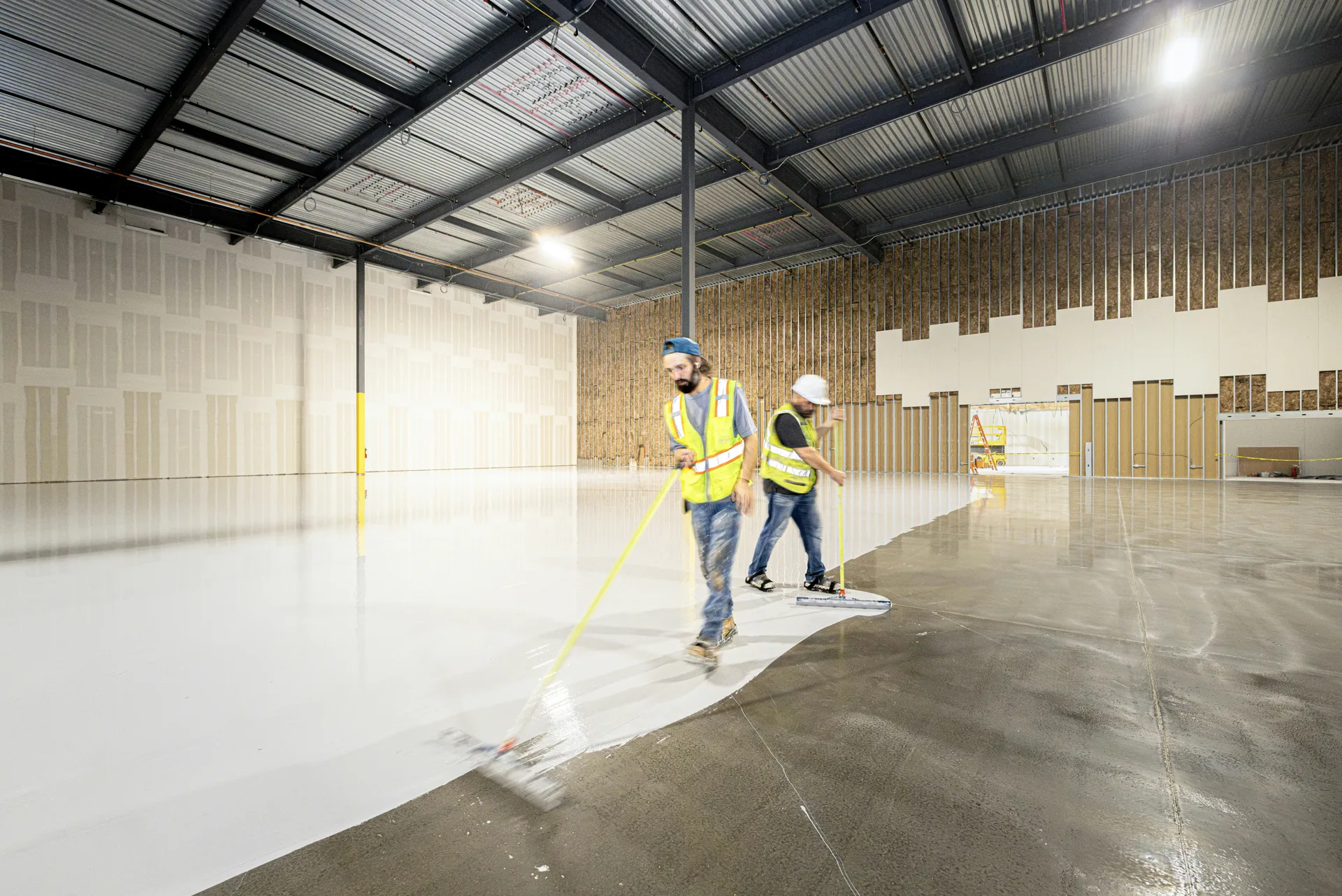 crew rolling epoxy onto a Minneapolis garage floor