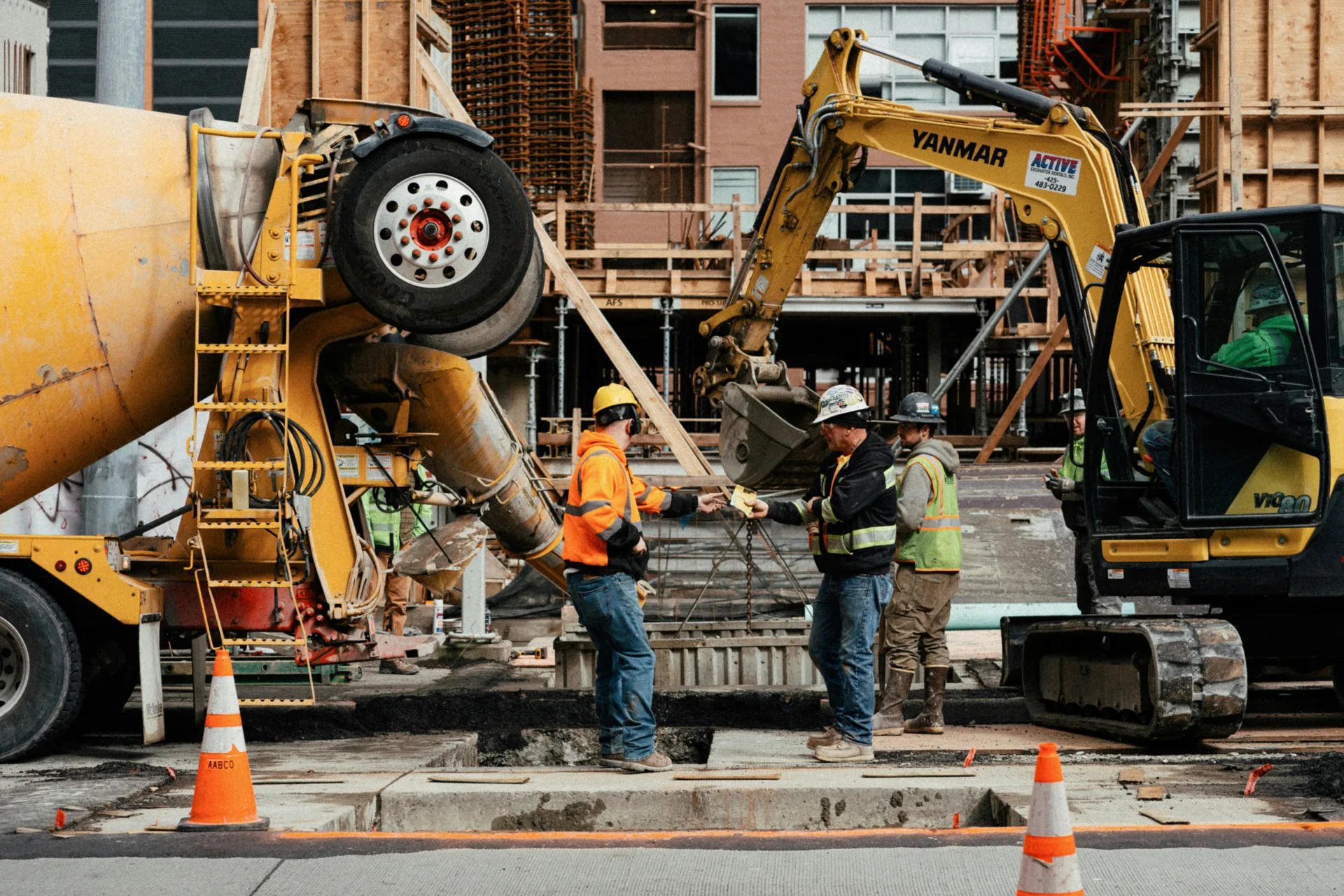 ready mix concrete pour on a Minneapolis urban site with a mini excavator