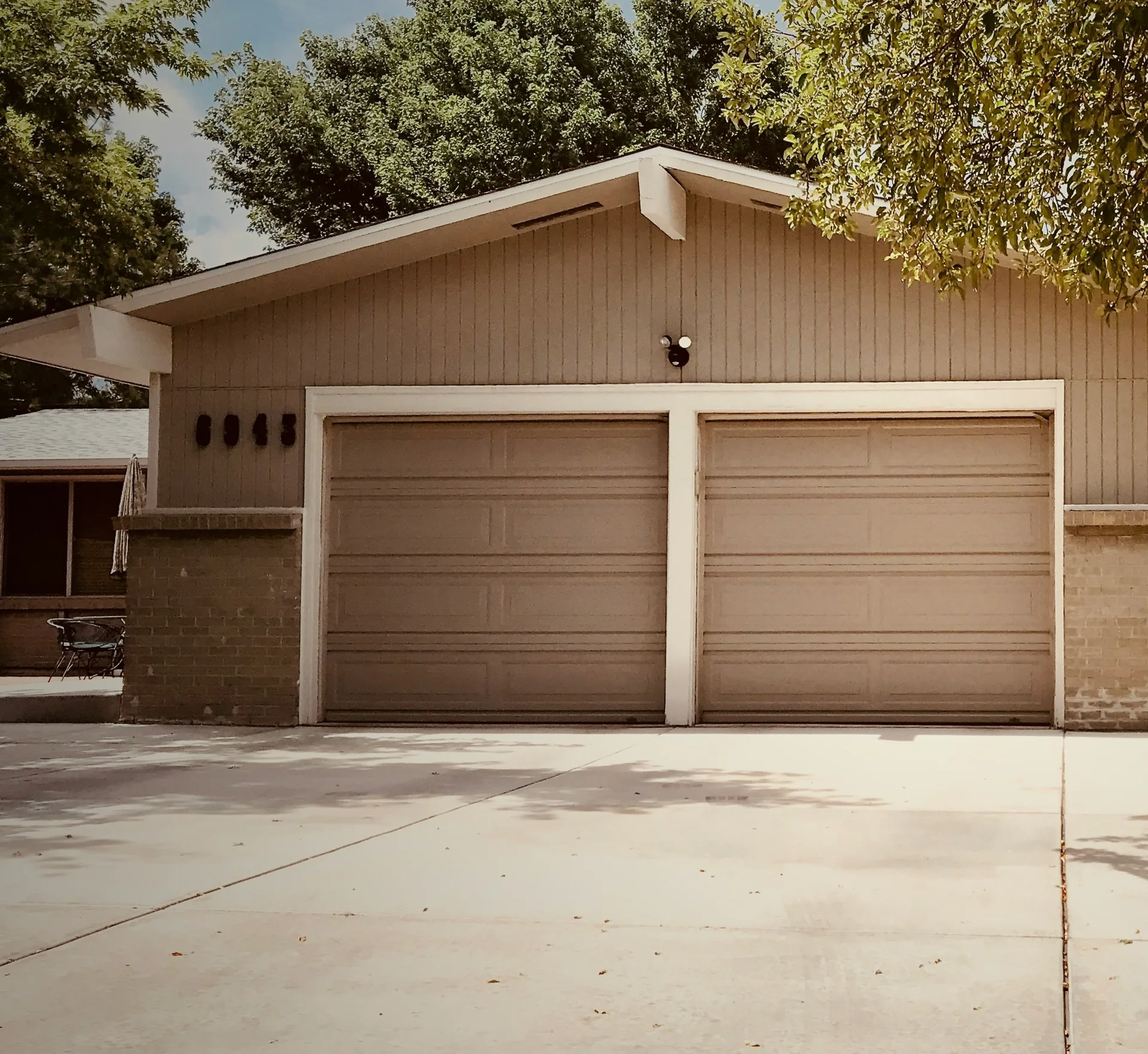concrete driveway at a ranch home with a double garage in Minneapolis