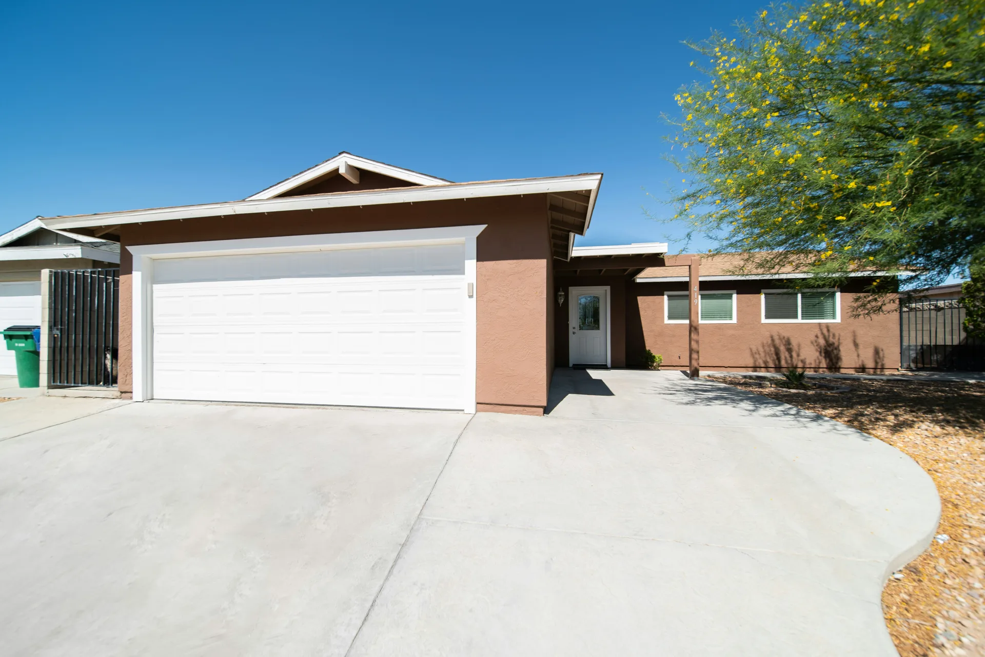 broom-finish concrete driveway at a Minneapolis stucco home