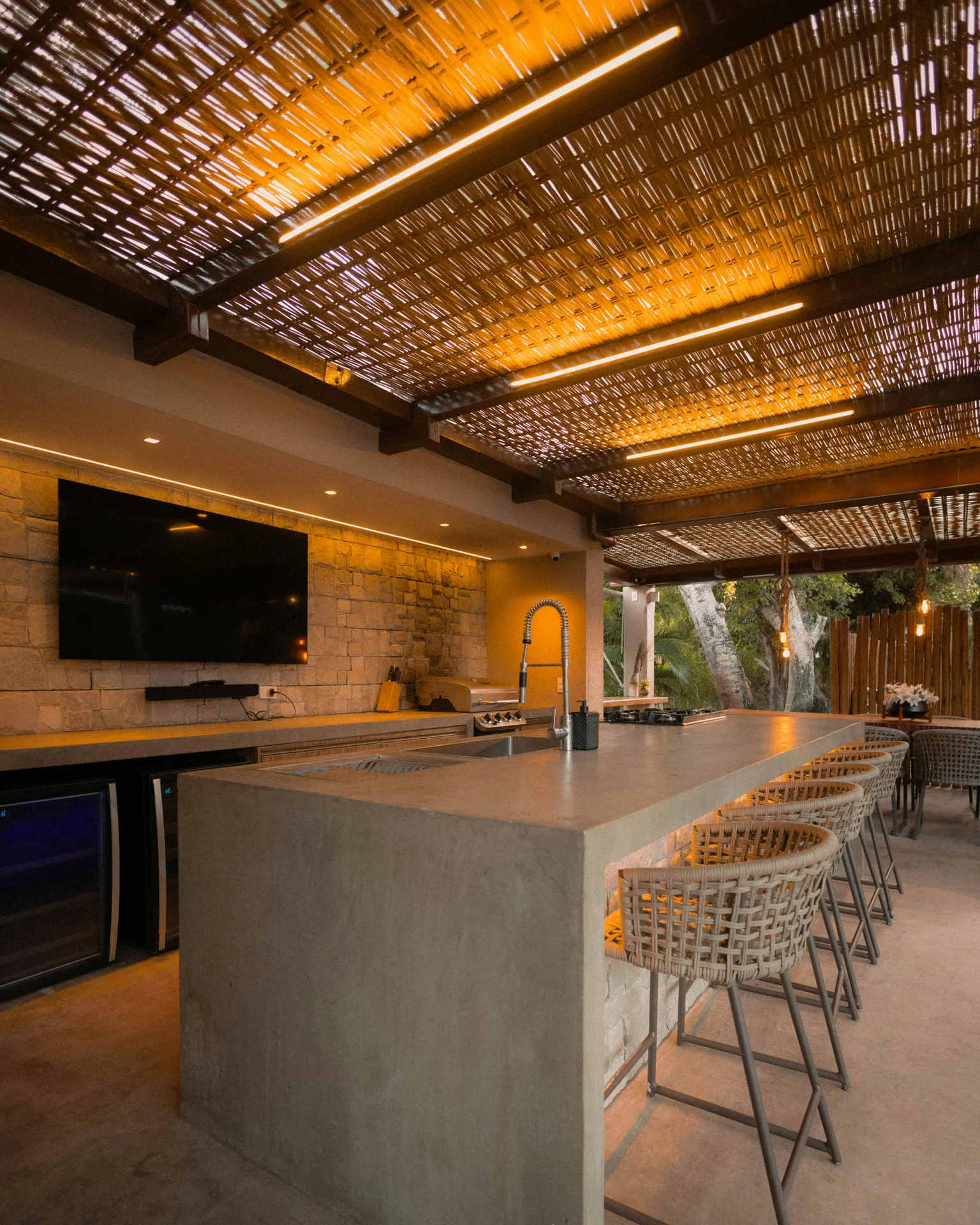 concrete outdoor kitchen bar under a pergola at a Minneapolis home